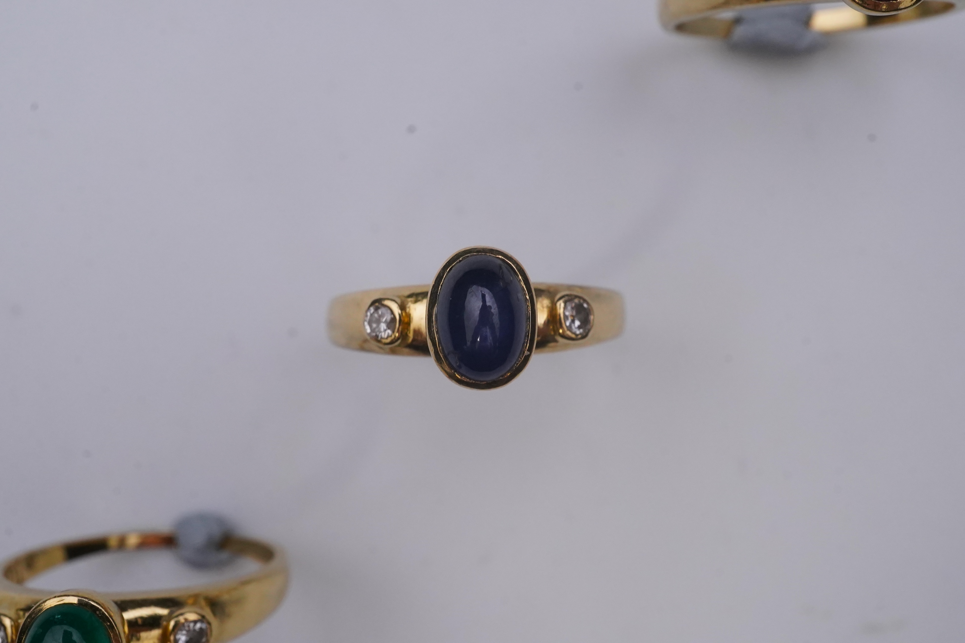 A suite of three gold and gem-set rings